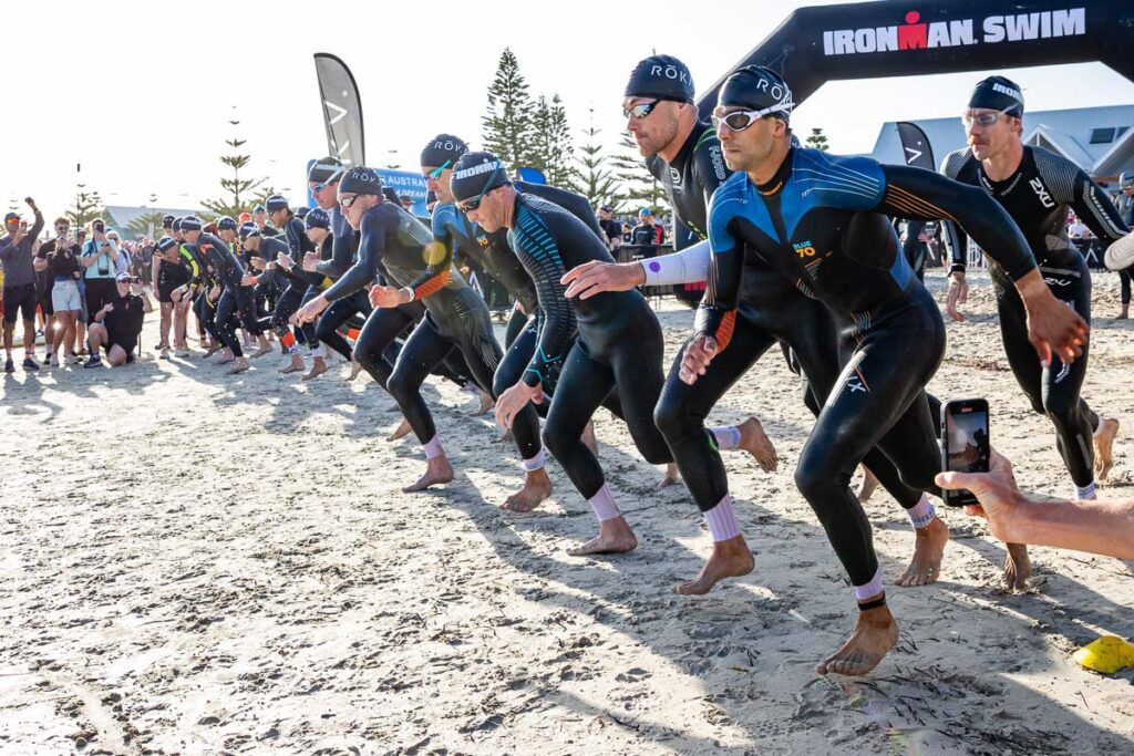 Iron Man swimmers running to the water to start swimming