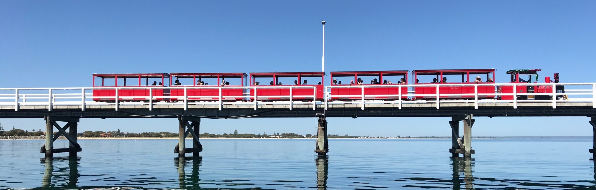 Train driving along the jetty from Water-Lisa Moore